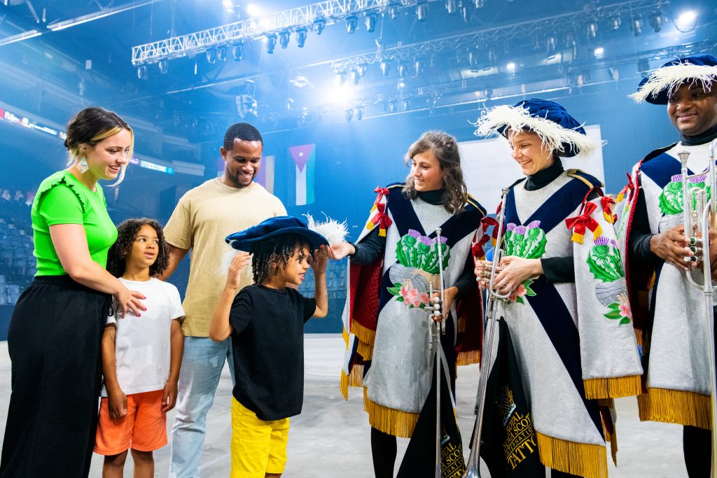 Family interacting with the Tattoo performance actors.